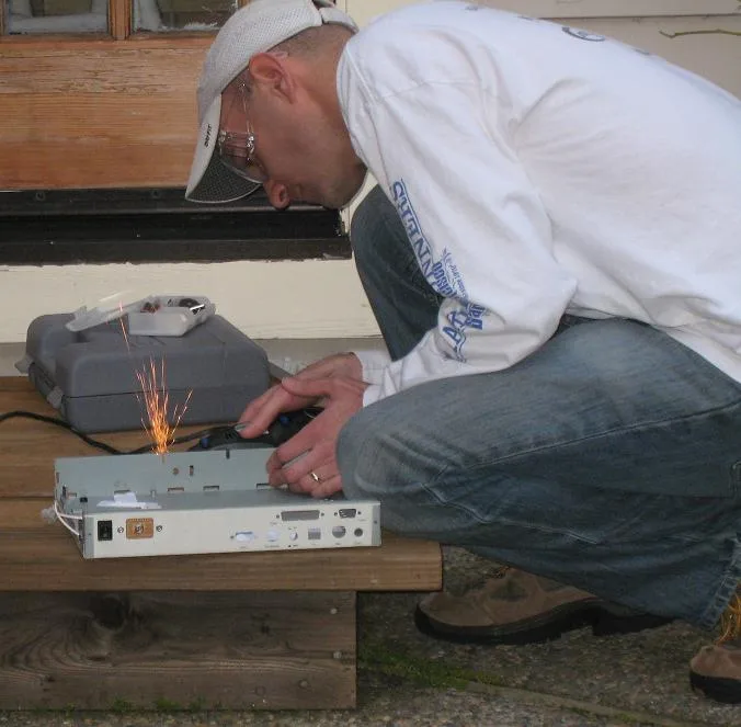 Cutting the steel case with a Dremel, sparks flying