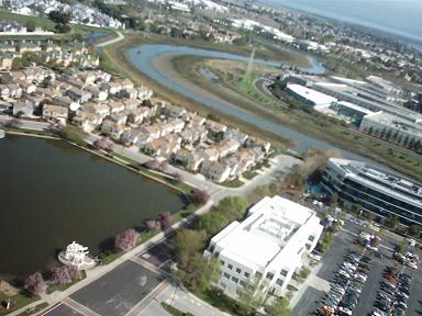 Aerial photo over homes and a lagoon