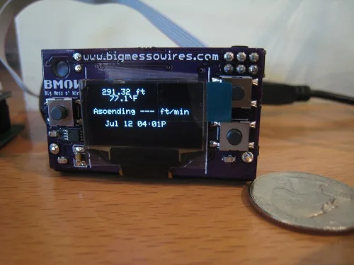 Assembled Logger Mini next to a coin