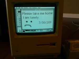 Mac Plus with a "Please take me home" note on screen