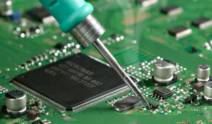 A logic probe testing a circuit board