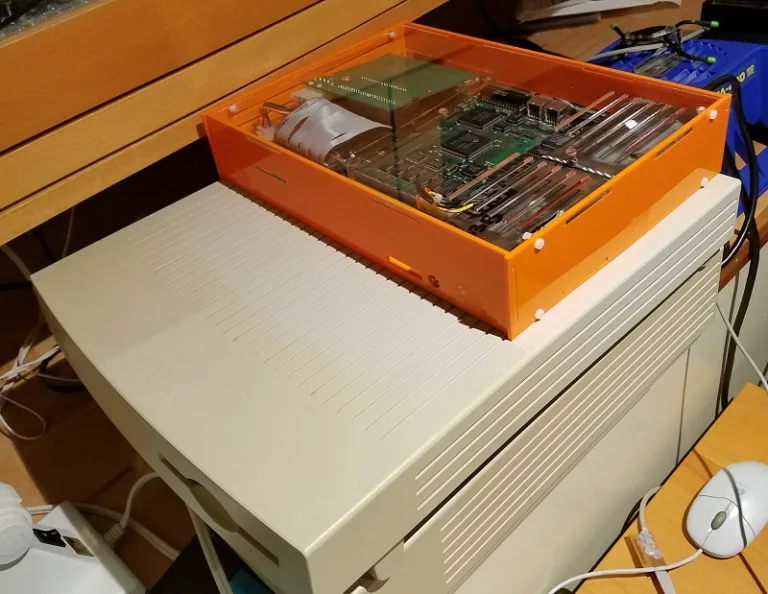 Orange laser-cut case for a Macintosh LC